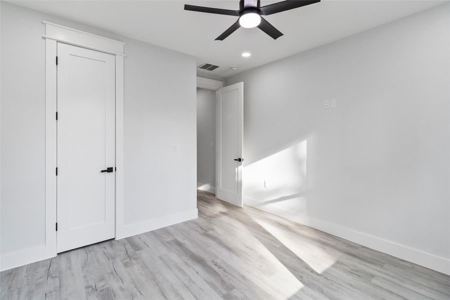 Unfurnished bedroom featuring light wood-style floors, recessed lighting, and a ceiling fan
