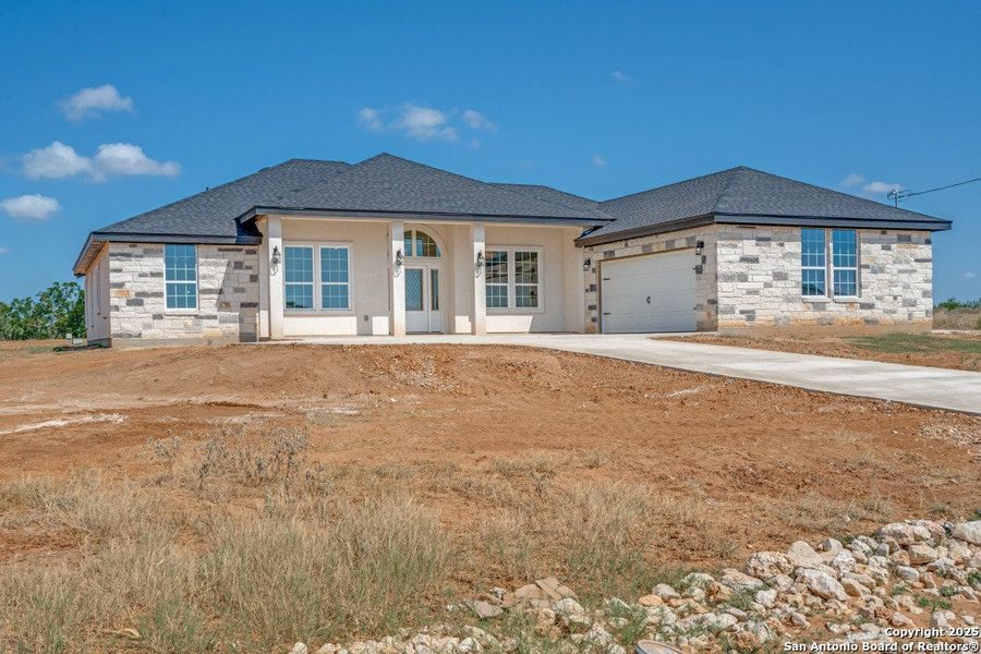 Front exterior of a new home in , Floresville, TX, highlighting curb appeal (Image 24).