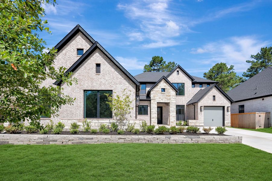 Front exterior of a new home in The Woodlands Hills - Premier Collection, Willis, TX, highlighting curb appeal (Image 28).