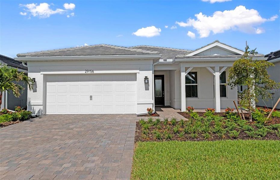 Front exterior of a new home in BeachWalk by Manasota Key, Englewood, FL, highlighting curb appeal (Image 1). Front exterior of a new home in BeachWalk by Manasota Key, Englewood, FL, highlighting curb appeal (Image 1).