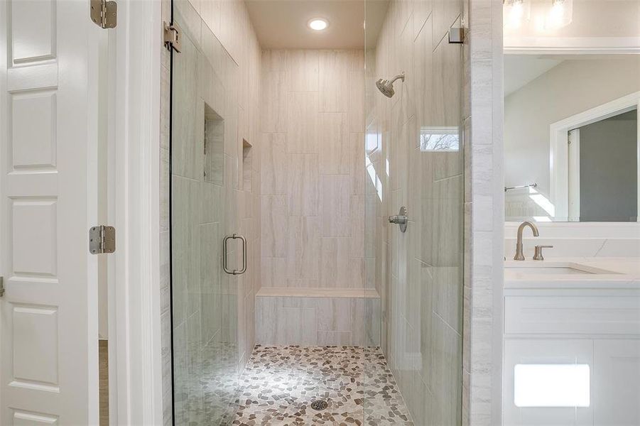 Bathroom with vanity and a shower with shower door