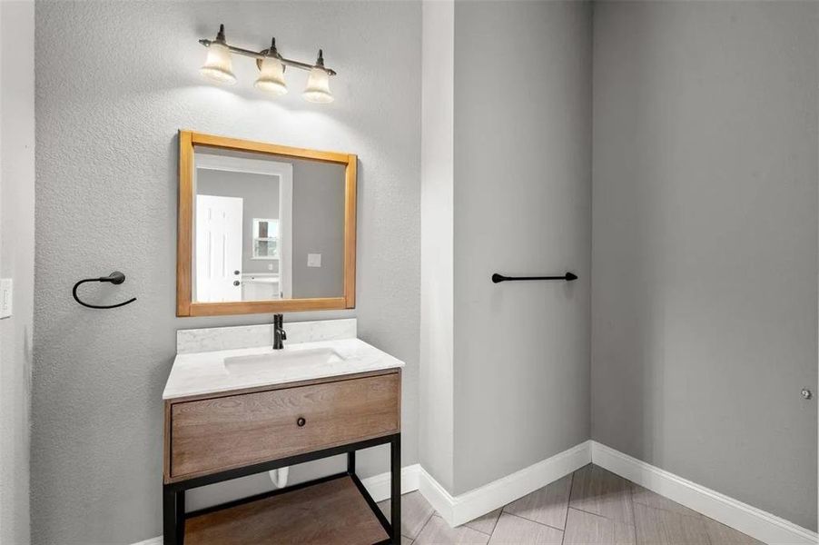 Bathroom featuring baseboards and vanity