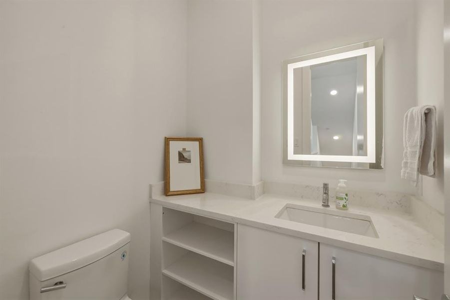 Half bath featuring vanity and toilet