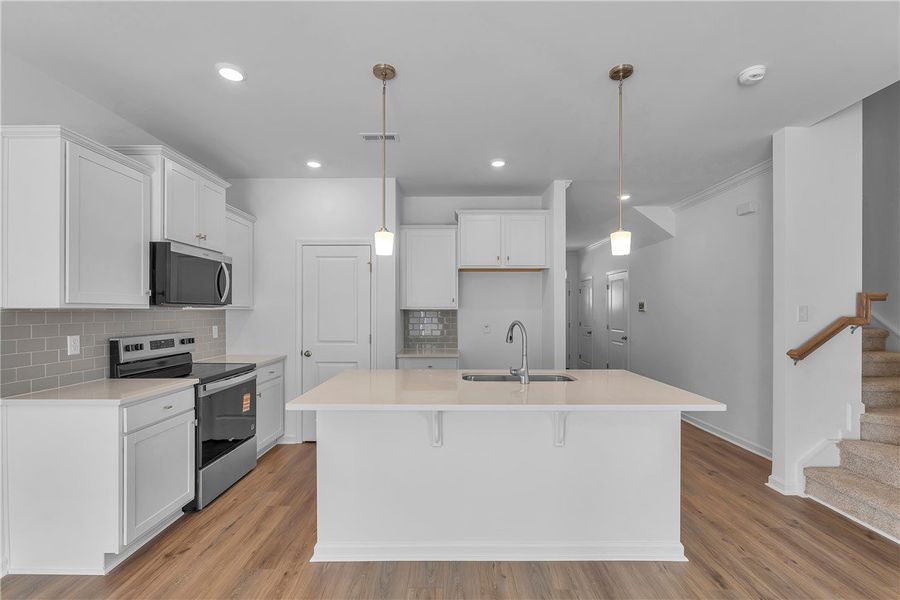 This bright and airy kitchen features modern appli This bright and airy kitchen features modern appli