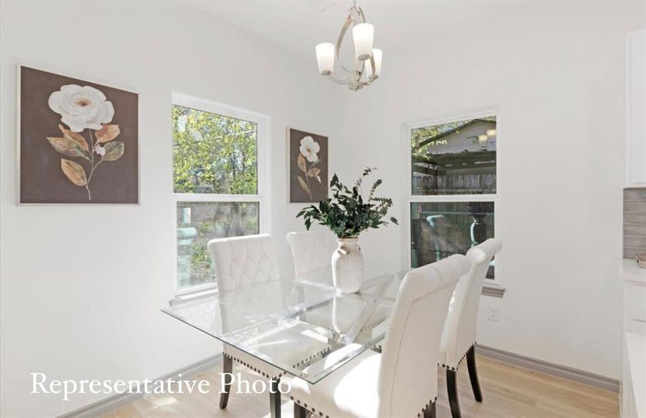 Dining area featuring an inviting chandelier and light hardwood / wood-style flooring