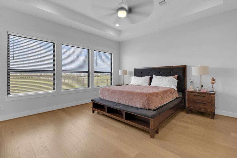 Spacious primary suite with large windows.