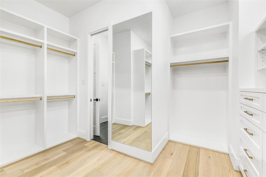 This angle showcases the floor-to-ceiling built-ins, custom hanging sections, and a designer full-length mirror—ideal for outfit styling and everyday convenience. Premium European white oak flooring continues through the space, tying seamlessly into the home’s high-end design palette. The thoughtful layout maximizes every inch for luxury-level functionality and style. This angle showcases the floor-to-ceiling built-ins, custom hanging sections, and a designer full-length mirror—ideal for outfit styling and everyday convenience. Premium European white oak flooring continues through the space, tying seamlessly into the home’s high-end design palette. The thoughtful layout maximizes every inch for luxury-level functionality and style.