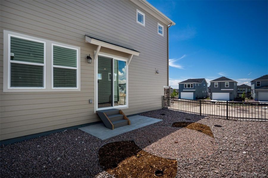 Front exterior of a new home in Revel Crossing at Wolf Ranch – The Ascent Collection, Colorado Springs, CO, highlighting curb appeal (Image 2).