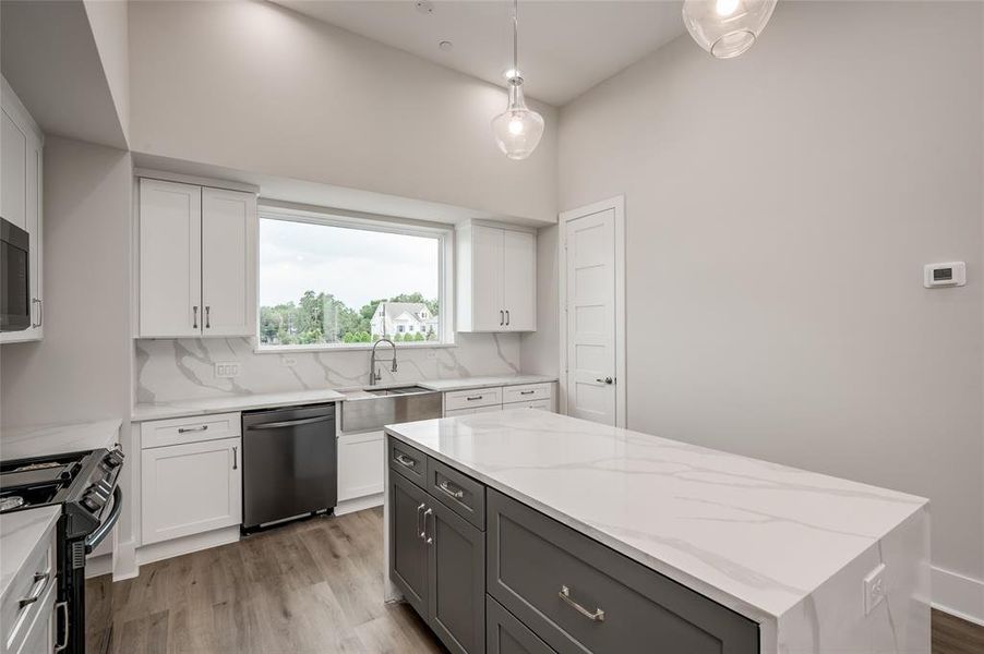 The kitchen island has extra storage and large drawers for pots and pans.