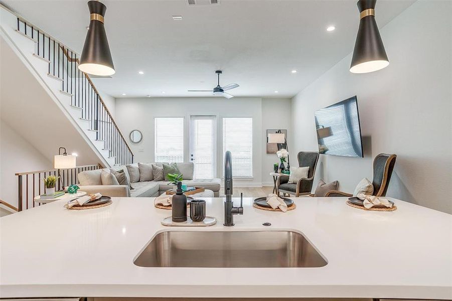 The kitchen, featuring an oversized island, is perfect for entertaining, offering ample space for meal prep, dining, and socializing, making it the ideal gathering spot for friends and family.