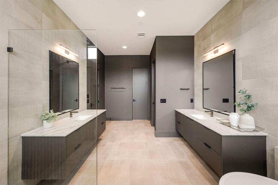 The spectacular dual vanities are a work of art, combining bold designer elements, expansive stone surfaces, exceptional storage, and flawless clean lines.