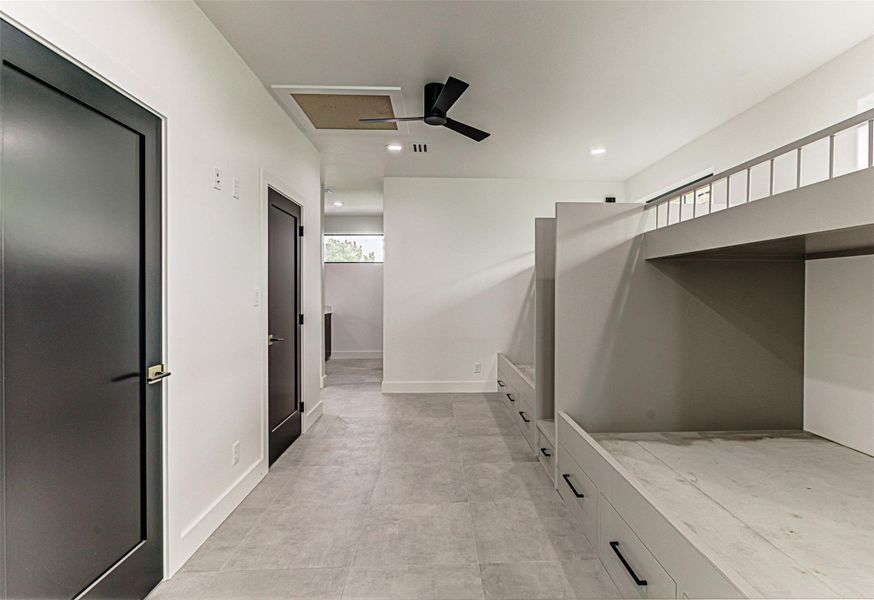 Bunkroom with custom bunkbeds, featuring recessed lighting and a healthy amount of sunlight