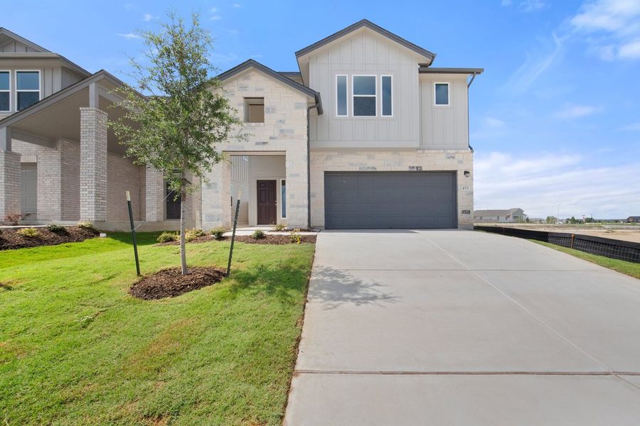 Front exterior of a new home in Porter Country, Buda, TX, highlighting curb appeal (Image 1). Front exterior of a new home in Porter Country, Buda, TX, highlighting curb appeal (Image 1).