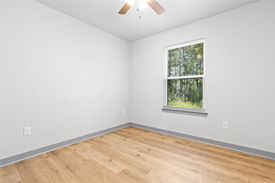 Spare room with wood finished floors and baseboards Spare room with wood finished floors and baseboards