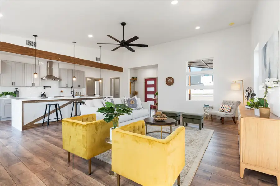 Living room featuring recessed lighting, a ceiling fan, visible vents, and wood-type flooring