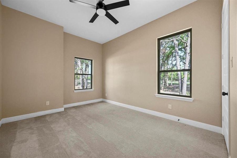 Empty room with light colored carpet and plenty of natural light