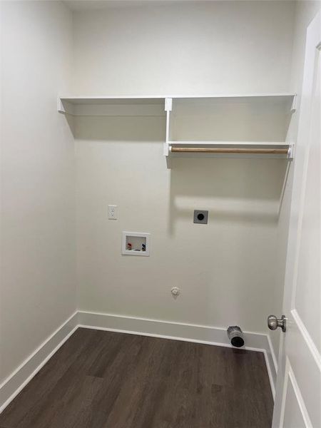 Laundry area featuring gas dryer hookup, hookup for an electric dryer, dark hardwood / wood-style floors, and hookup for a washing machine