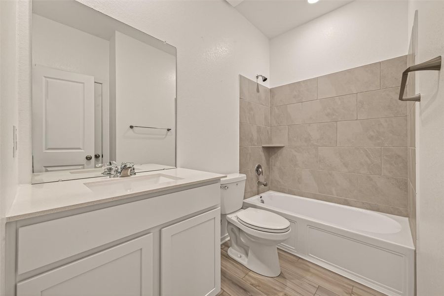 Well-designed secondary bath with modern finishes, ample counter space, and a functional layout for everyday convenience.