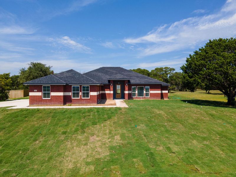 Prairie-style house featuring brick siding and a front yard