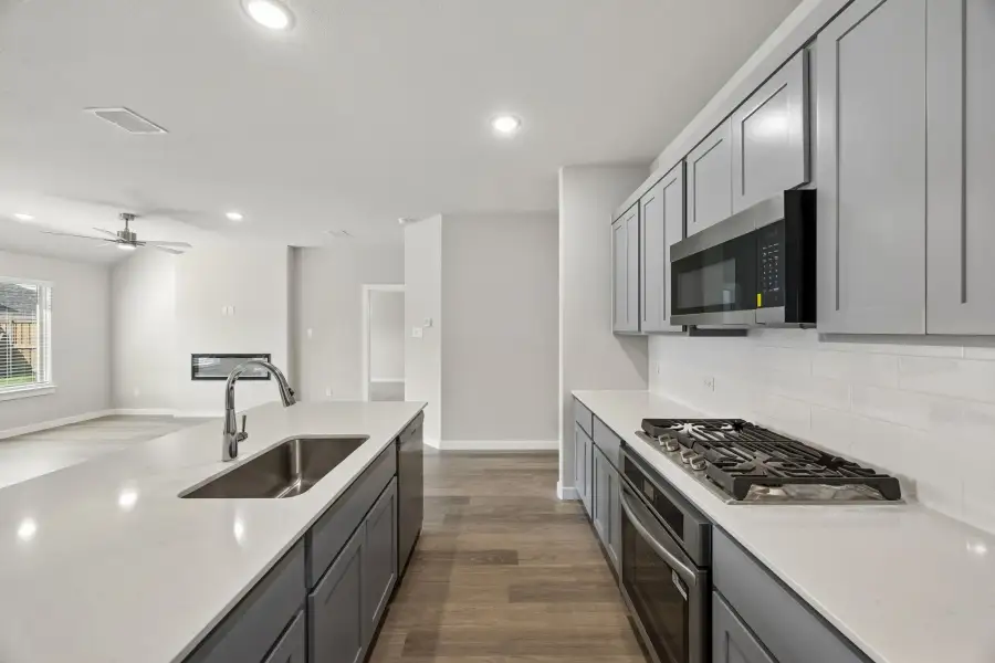 Kitchen in the Emmy II home plan by Trophy Signature Homes - REPRESENTATIVE PHOTO