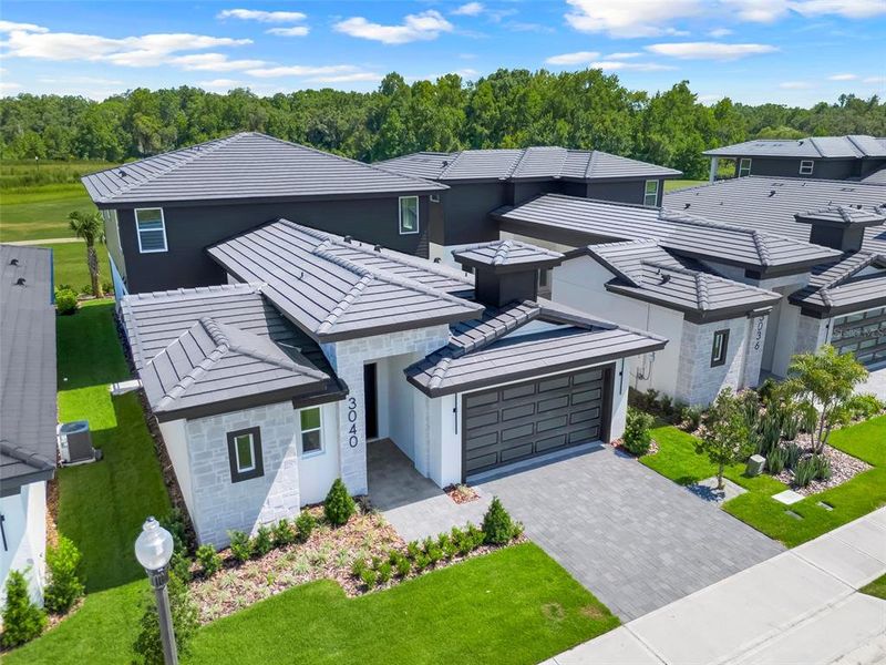 Front exterior of a new home in Hampton Green at Providence, Davenport, FL, highlighting curb appeal (Image 26).