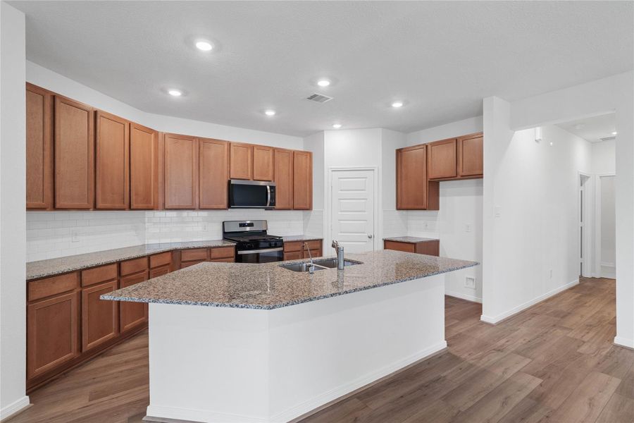 This spacious kitchen has it all—ample storage, generous counter space, and a layout that truly makes it the heart of the home. This spacious kitchen has it all—ample storage, generous counter space, and a layout that truly makes it the heart of the home.
