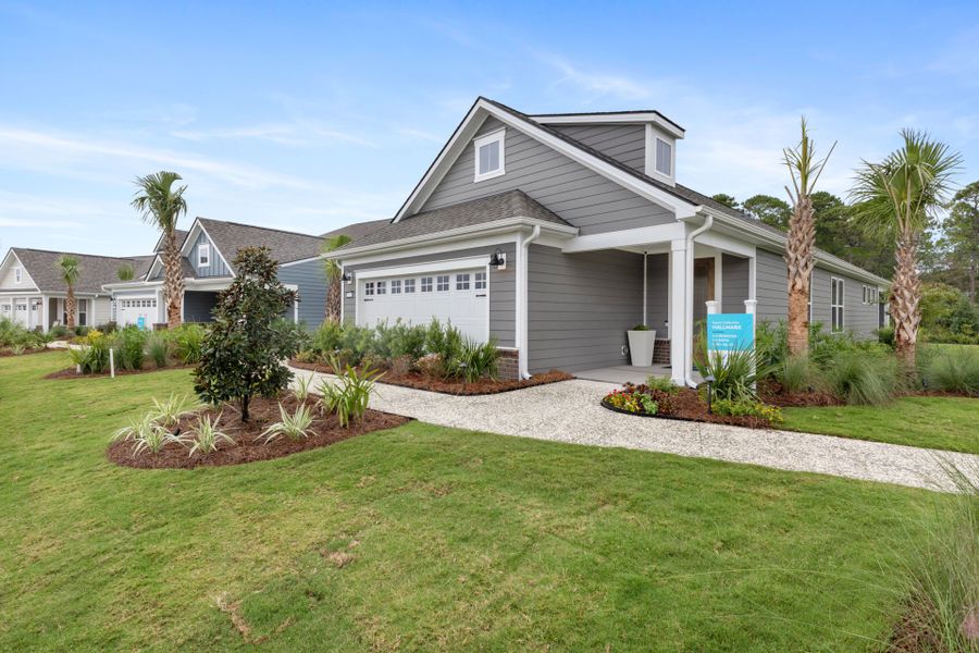 Front exterior of a new home in Del Webb Ocean Isle Beach, Shallotte, NC, highlighting curb appeal (Image 16).