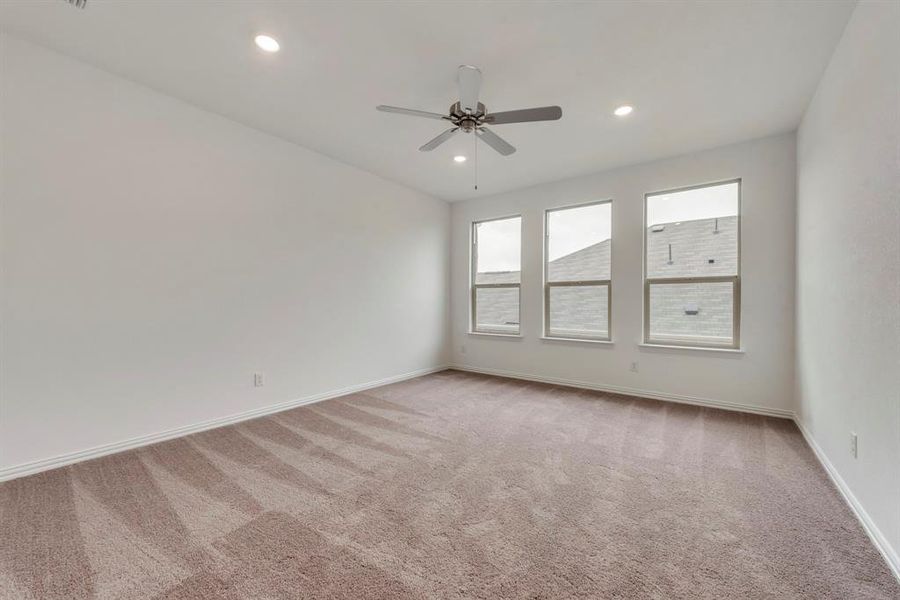 Unfurnished room featuring carpet and ceiling fan