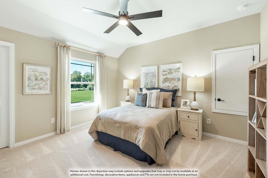 Bedroom with vaulted ceiling, ceiling fan, carpet flooring, and large window with garden view Bedroom with vaulted ceiling, ceiling fan, carpet flooring, and large window with garden view