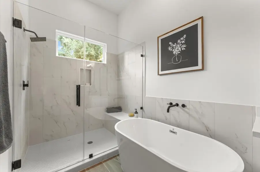 Elegant and serene primary bathroom designed to offer both style and functionality. The space features a luxurious soaking tub ideal for unwinding, a separate glass-enclosed shower for quick refreshes, and a sleek double vanity with ample countertop space and storage—perfect for busy mornings or relaxing evenings. Elegant and serene primary bathroom designed to offer both style and functionality. The space features a luxurious soaking tub ideal for unwinding, a separate glass-enclosed shower for quick refreshes, and a sleek double vanity with ample countertop space and storage—perfect for busy mornings or relaxing evenings.