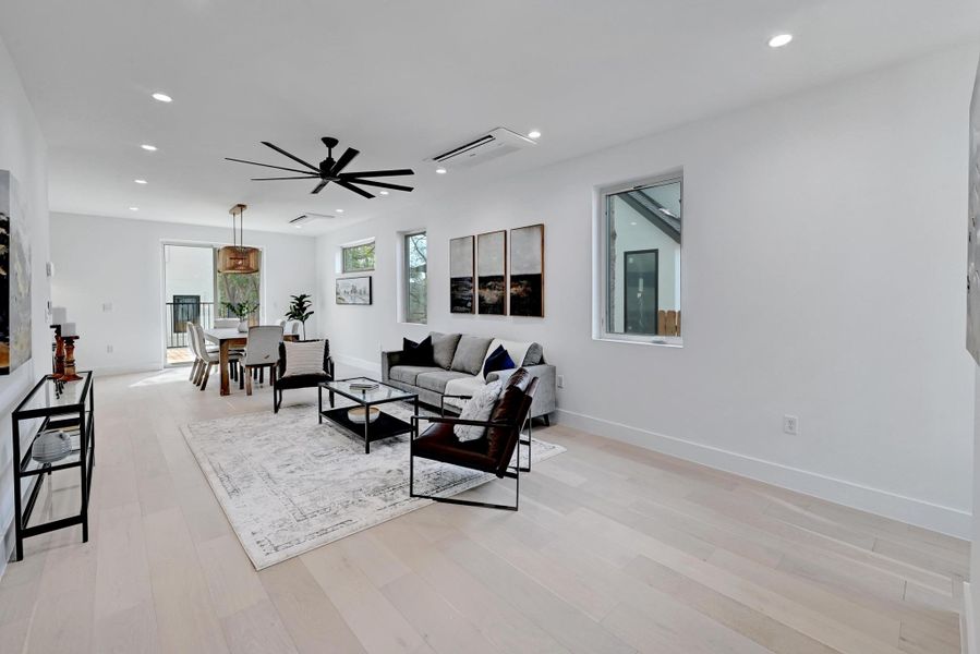 Living room featuring recessed lighting, light wood-type flooring, and ceiling fan