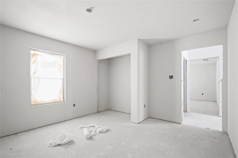 Property interior featuring a window, an open doorway, and a recessed ceiling light