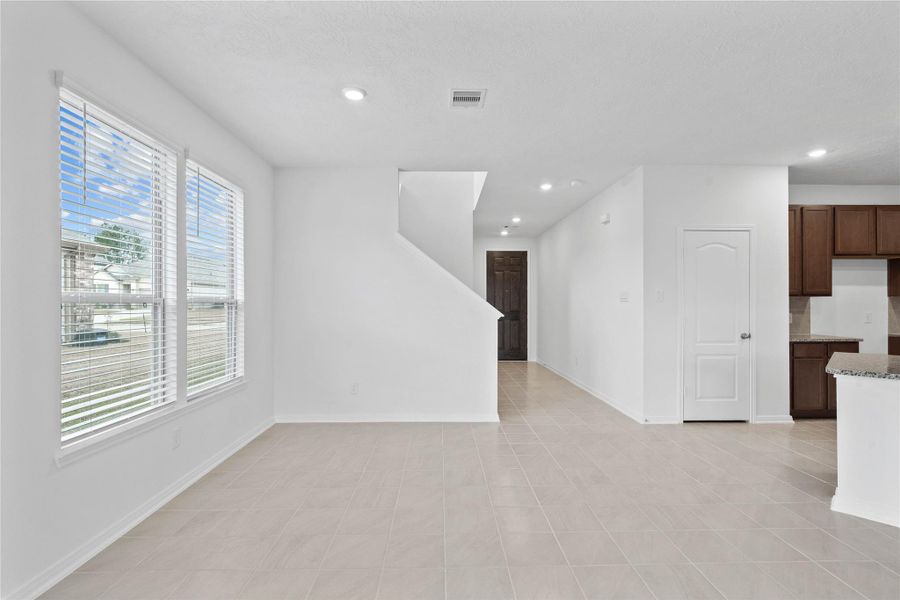 Start your day off right with a cup of coffee sitting with your family in the lovely dining area! Featuring large windows with privacy blinds, custom paint, tile flooring and recessed lighting.