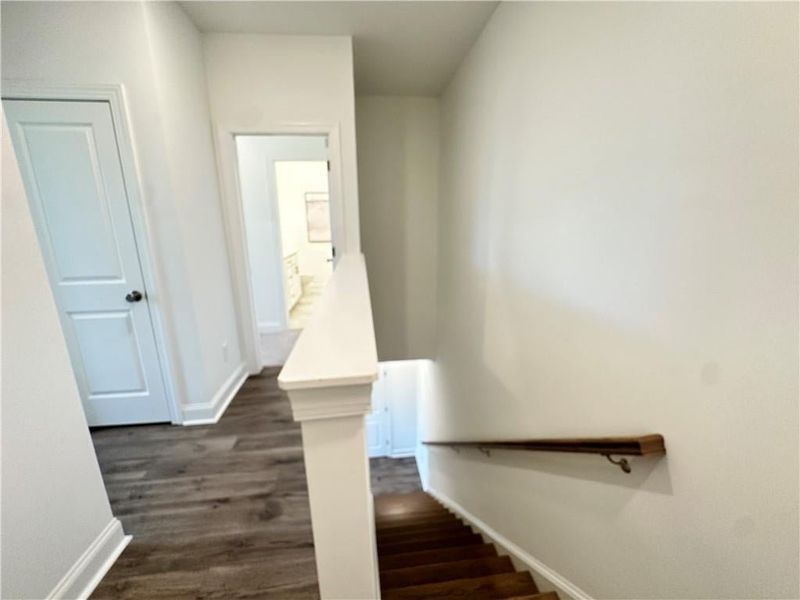 Hallway features hardwoods with additional linen closet *photos are from the Magnolia model at different home site*