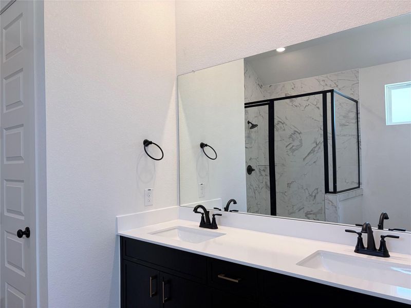 Clean lines and a spacious dual vanity highlight this contemporary bathroom. Clean lines and a spacious dual vanity highlight this contemporary bathroom.