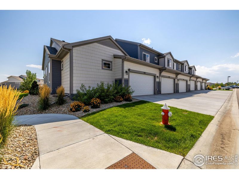 Front exterior of a new home in , Loveland, CO, highlighting curb appeal (Image 23).