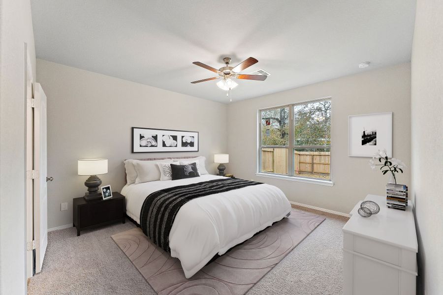 A bedroom with a bed and a fan.