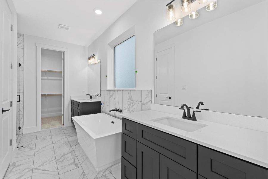 Bathroom with vanity and a tub