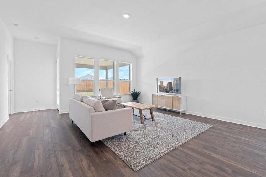 Living area featuring dark wood-style floors and recessed lighting Living area featuring dark wood-style floors and recessed lighting