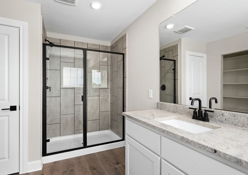 The master bathroom has a glass, walk-in shower.