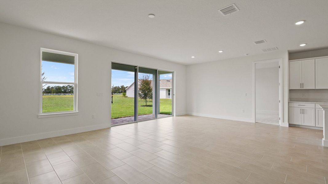 Living Area with a view of the back yard of the Buttonwood floorplan by DRB Homes at Lakeside at Satilla in Saint Cloud, FL