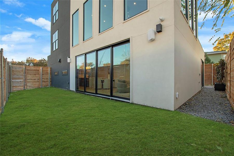 Rear view of house featuring a yard