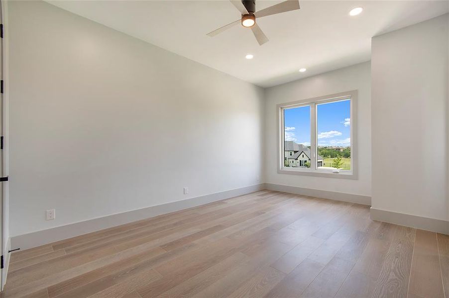 Spare room with ceiling fan, light wood-style floors, and recessed lighting