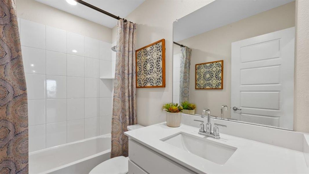 Bathroom featuring vanity and shower / tub combo Bathroom featuring vanity and shower / tub combo