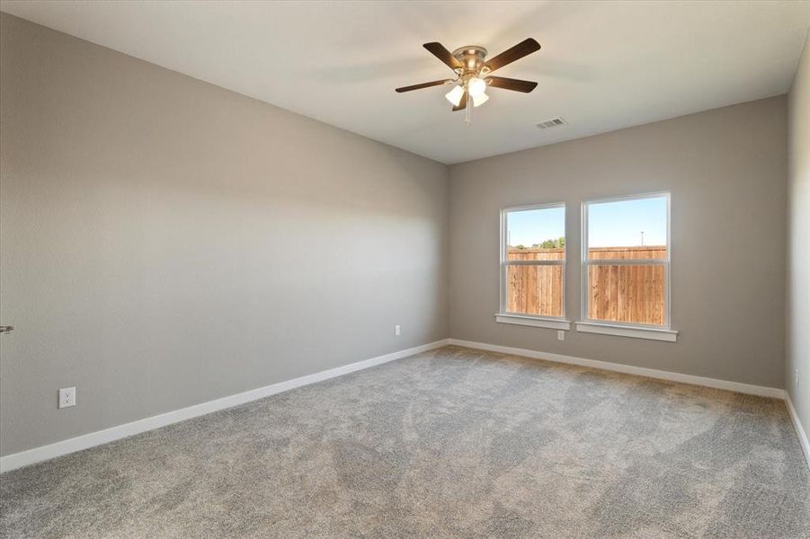 Carpeted spare room featuring ceiling fan Carpeted spare room featuring ceiling fan