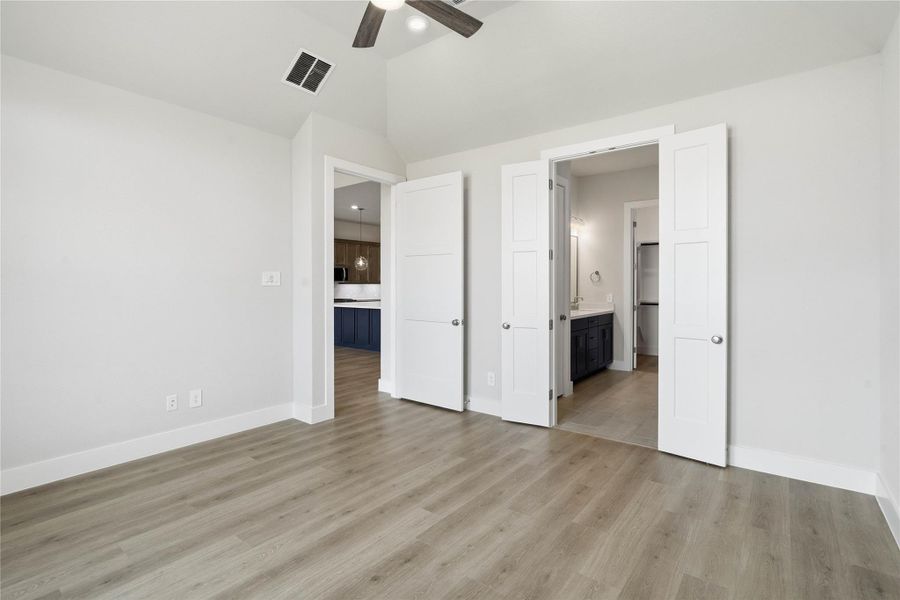 Additional view from the primary bedroom looking towards the ensuite primary bathroom and the double door entrance!