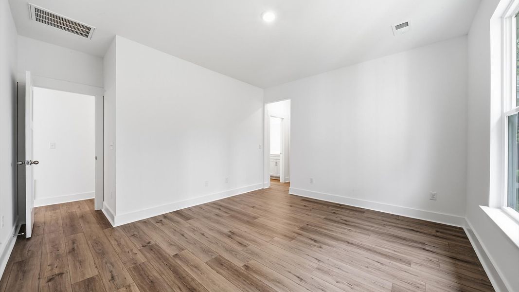 Eye-catching details and elegant finishes in the vibrant primary suite of this select home Eye-catching details and elegant finishes in the vibrant primary suite of this select home