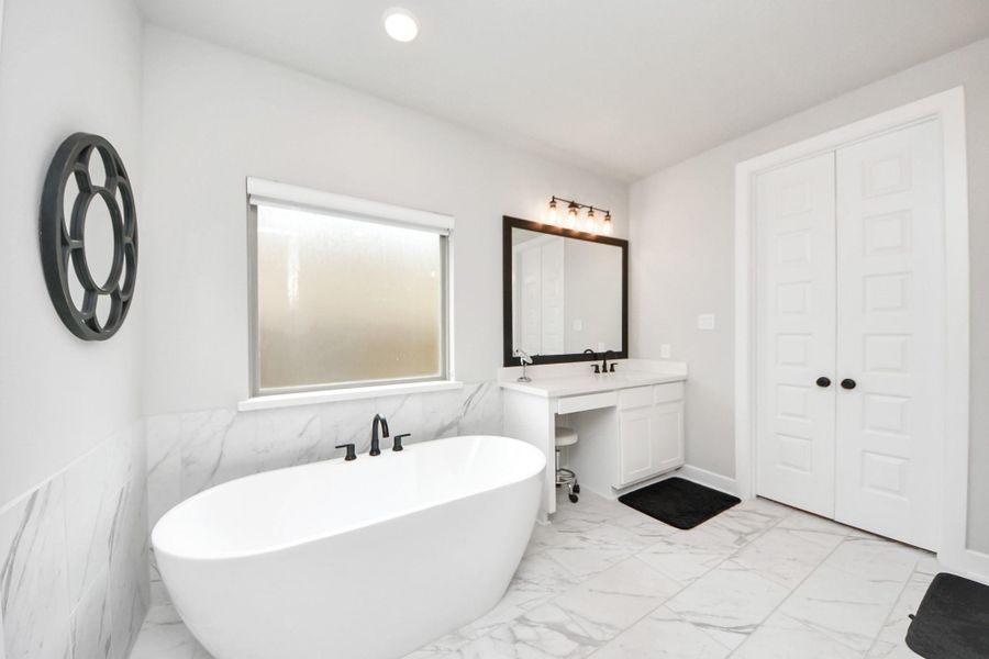 Spa-inspired en-suite with large freestanding tub.
