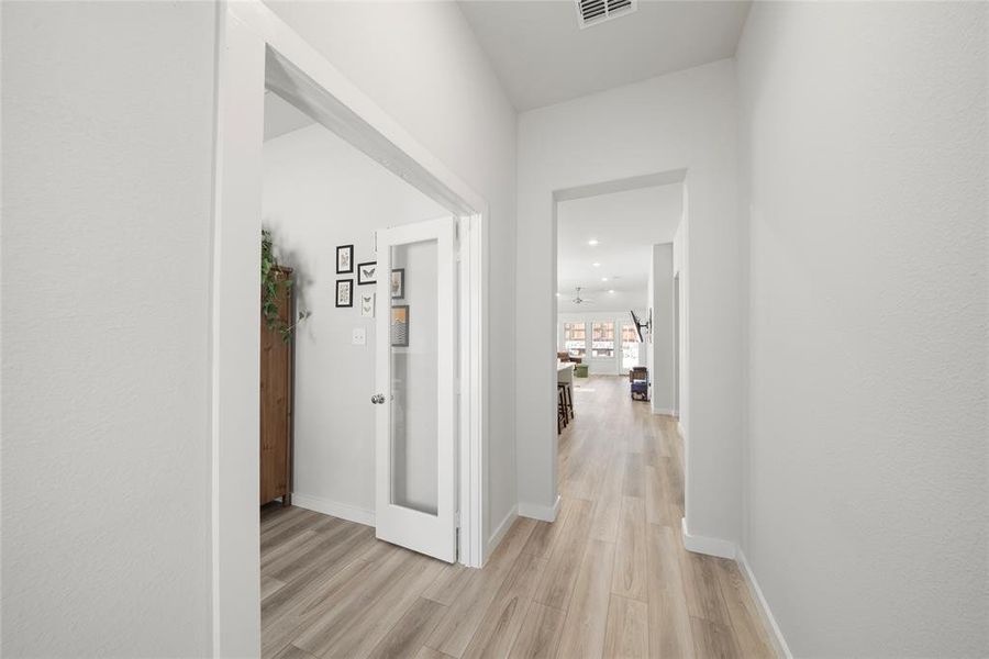 Hall with light hardwood / wood-style flooring