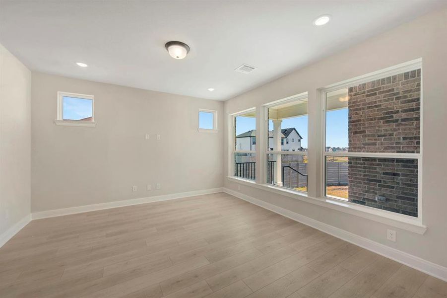 Empty room featuring light wood finished floors and recessed lighting